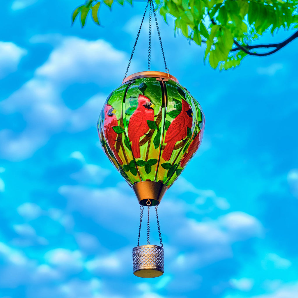 Solar lantern with hand-painted cardinal bird in red hues, perfect for front yard decor and patio solar lighting